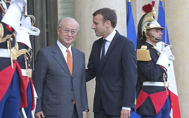 French President Emmanuel Macron, left, welcomes Director General of the International Atomic Energy Agency, IAEA, Yukiya Amano for a meeting at the Elysee Palace in Paris, France on October 19, 2017. (AP/Michel Euler)