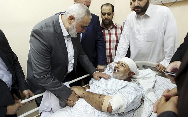 In this photo released by the Hamas media office, Ismail Haniyeh, head of the Hamas terror group's political bureau, visits Tawfiq Abu Naim at Shifa Hospital in Gaza City on October 27, 2017. (Mohammad Austaz, Hamas Media Office via AP)