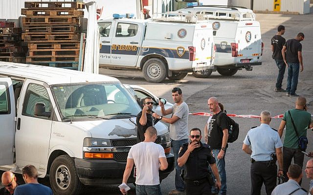 Police gather at the crime scene in Kafr Qassem where Reuven Schmerling was found murdered, on October 4, 2017. (Roy Alima/Flash90)