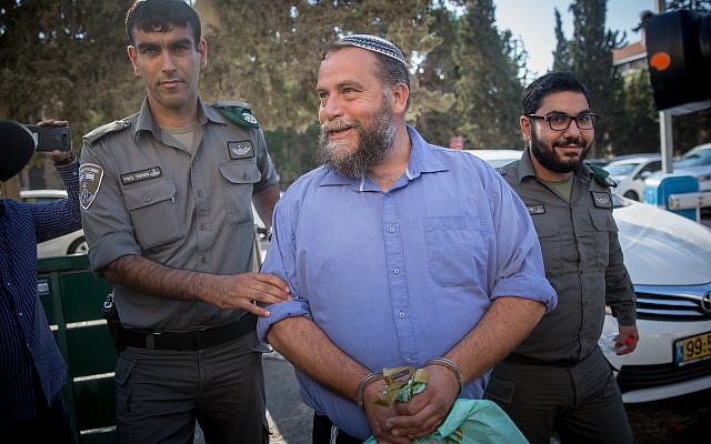 Lehava chairman Benzi Gopstein is brought to the Jerusalem Magistrate's Court, October 22, 2017 (Yonatan Sindel/Flash90)