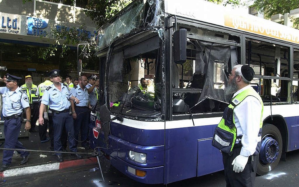 Illustrative: Israeli police and aid workers search the scene of a suicide bomb attack in a bus on September 19, 2002 in Tel Aviv. (Rahanan Cohen/Israel Defense Forces/Getty Images via JTA/File)