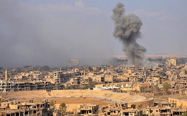 Illustrative: Smoke billows from the eastern city of Deir Ezzor during an operation by Syrian government forces against Islamic State (IS) group jihadists on November 2, 2017. (AFP/Stringer)