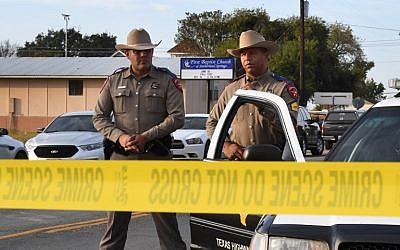 State troopers guard the entrance to the First Baptist Church (back), on November 6, 2017, after a mass shooting that killed 26 people in Sutherland Springs, Texas. (AFP Photo/Mark Ralston)