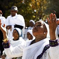 Illustrative: Israeli women from the Ethiopian Jewish community pray during the Sigd holiday marking the desire to 'return to Jerusalem,' as they celebrate from a hilltop in the holy city overlooking the Temple Mount, on November 16, 2017. (AFP Photo/Gali Tibbon)