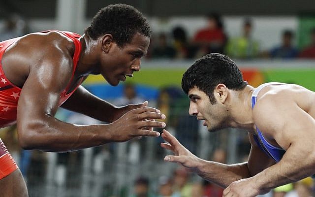 This file photo taken on August 20, 2016 shows USA's J'den Michael Tbory Cox (red) wrestling with Iran's Ali Reza Karimi during a match at the 2016 Olympic Games in Rio de Janeiro. (AFP Photo/Jack Guez)