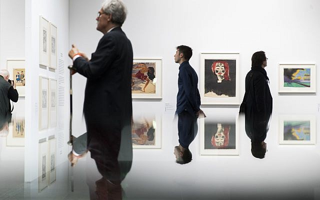 Visitors look at paintings in the exhibition 'Status Report Gurlitt.  degenerate art - confiscated and sold'  in the Kunstmuseum in Bern, Switzerland, November 1, 2017. (Peter Klaunzer/Keystone via AP)