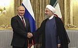 In this photo released by an official website of the office of the Iranian Presidency, Iran's President Hassan Rouhani, right, shakes hands with Russian President Vladimir Putin during their meeting at the Saadabad Palace in Tehran, Iran, Wednesday, Nov. 1, 2017. (Iranian Presidency Office via AP)