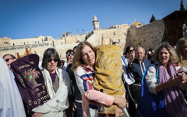 Members of the Reform movement hold Torah scrolls during a mixed men and women prayer at the public square in front of the Western Wall, in Jerusalem's Old City, November 16, 2017. (Noam Rivkin Fenton)