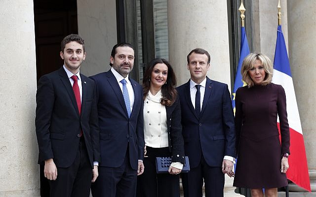 French President Emmanuel Macron, center right, and his wife Brigitte, right, greet Lebanon's Prime Minister Saad Hariri, second left, his wife Lara, center left, and their son Hussam upon their arrival at the Elysee Palace in Paris, November 18, 2017. (AP Photo/Christophe Ena)