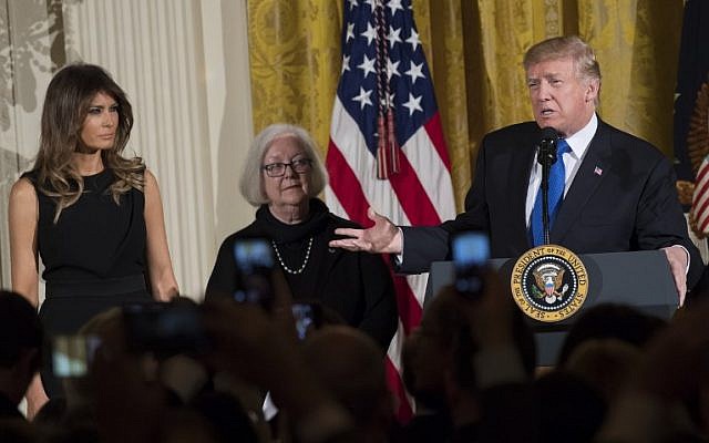 US President Donald Trump speaks alongside First Lady Melania Trump (L), and Holocaust survivor Louise Lawrence-Israels (C) during a Hanukkah reception in the East Room of the White House in Washington, DC, December 7, 2017. (AFP PHOTO / SAUL LOEB)