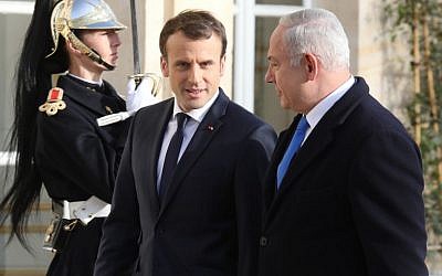 French President Emmanuel Macron, left, welcomes Prime Minister Benjamin Netanyahu upon his arrival at the Elysee Palace on December 10, 2017 in Paris. (AFP/Ludovic Marin)