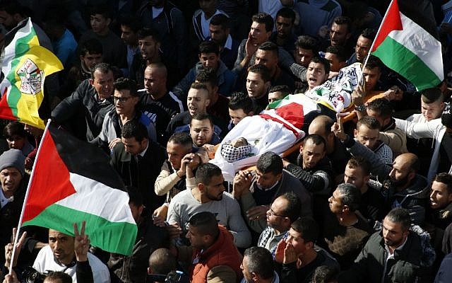 Mourners carry the body of Mohammed Aqal, a Palestinian assailant killed after carrying out a stabbing attack on a Border Police officer, during his funeral in the West Bank village of Beit Ula on December 16, 2017. (AFP Photo/ Hazem Bader)