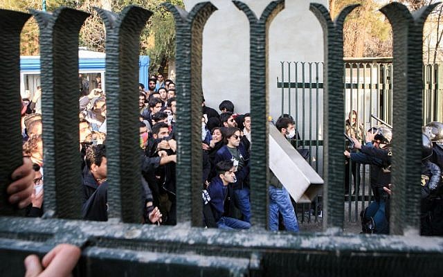 Iranian students scuffle with police at the University of Tehran during a demonstration driven by anger over economic problems, in the capital Tehran on December 30, 2017. 
Students protested in a third day of demonstrations, videos on social media showed, but were outnumbered by counter-demonstrators. (AFP PHOTO / STR)