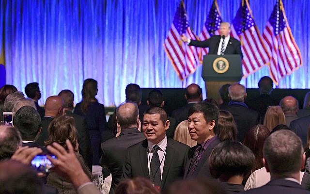 People in the audience have their photo taken as President Donald Trump speaks at a fundraiser at Cipriani in New York, Saturday, Dec. 2, 2017 (AP Photo/Susan Walsh)