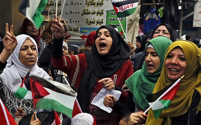 Palestinian women chant slogans as they hold Palestinian flags during a sit-in in the Bourj al-Barajneh Palestinian refugee camp, in Beirut, Lebanon, December 6, 2017. (AP Photo/Bilal Hussein)