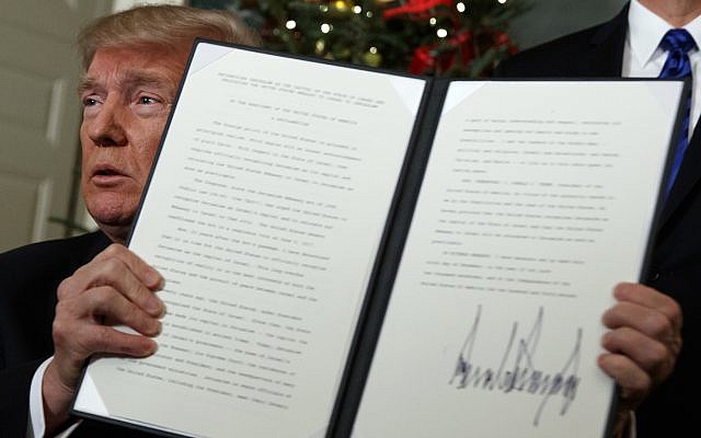 US President Donald Trump holds up a proclamation to officially recognize Jerusalem as the capital of Israel, in the Diplomatic Reception Room of the White House, on Dec. 6, 2017. (AP Photo/Evan Vucci)
