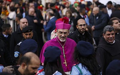 The Latin Patriarch of Jerusalem Pierbattista Pizzaballa arrives to the Church of the Nativity, built atop the site where Christians believe Jesus Christ was born, on Christmas Eve, in the West Bank City of Bethlehem, Sunday, Dec. 24, 2017. (AP Photo/Majdi Mohammed)