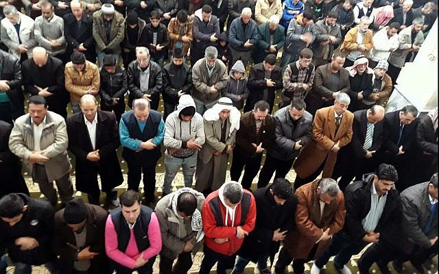 In this photo released by the Syrian official news agency SANA, Syrian citizens pray for rain during the Friday prayer, in Hasakeh, Syria, on December 29, 2017. (SANA via AP)