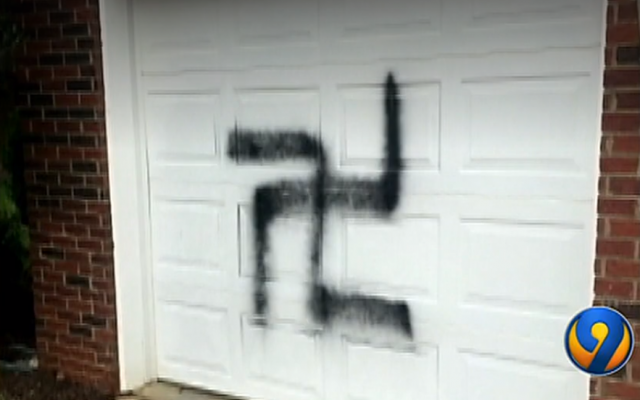 A swastika painted on the garage of a Jewish family near Charlotte, North Carolina. (Screen capture: WSOCTV)