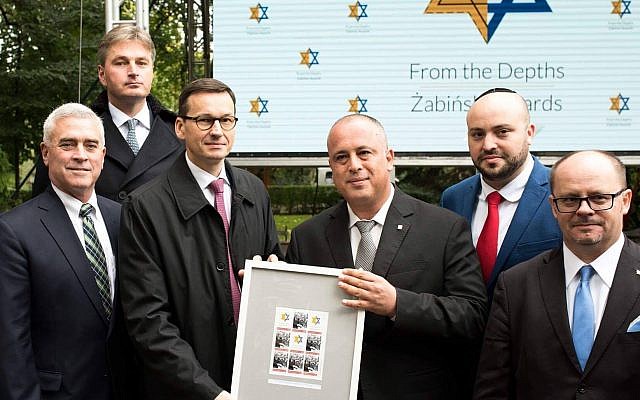 Mateusz Morawiecki, third from left, at the Warsaw Zoo holding a document honoring rescuers of Jews, Sept. 18, 2017. (Courtesy of From the Depths)