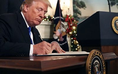 US President Donald Trump signing a proclamation that the US government will formally recognize Jerusalem as the capital of Israel, at the White House in Washington, DC, December 6, 2017. (Chip Somodevilla/Getty Images via JTA)