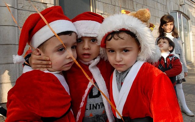 Arab Israeli children attend a Christmas parade outside the Church of the Annunciation in the northern Arab city of Nazareth, December 24, 2009. (Gili Yaari/Flash90)