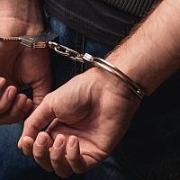 Illustrative image of a criminal in handcuffs. (YakobchukOlena/iStock, by Getty Images)