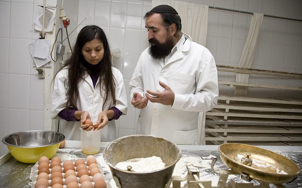 Rabbi Elisha Salas, right, instructing a baker in Belmonte, Portugal, in the preparation of kosher challah, April 2012. (Courtesy of Shavei Israel/via JTA)