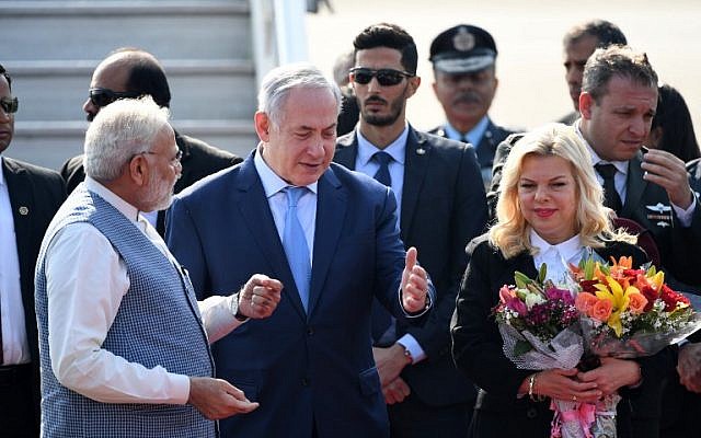 Indian Prime Minister Narendra Modi, left, welcomes Prime Minister Benjamin Netanyahu, center, and his wife Sara Netanyahu on their arrival at the Air Force Station in New Delhi on January 14, 2018. (PRAKASH SINGH/AFP)