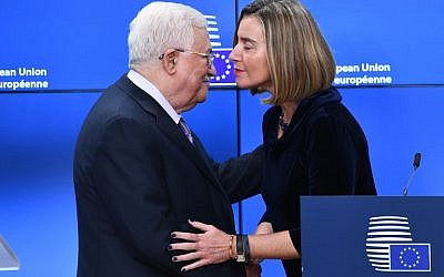 Palestinian Authority President Mahmoud Abbas (L) is welcomed by EU foreign policy chief Federica Mogherini prior to attending a EU foreign affairs council at the European Council in Brussels, January 22, 2018. (EMMANUEL DUNAND / AFP)