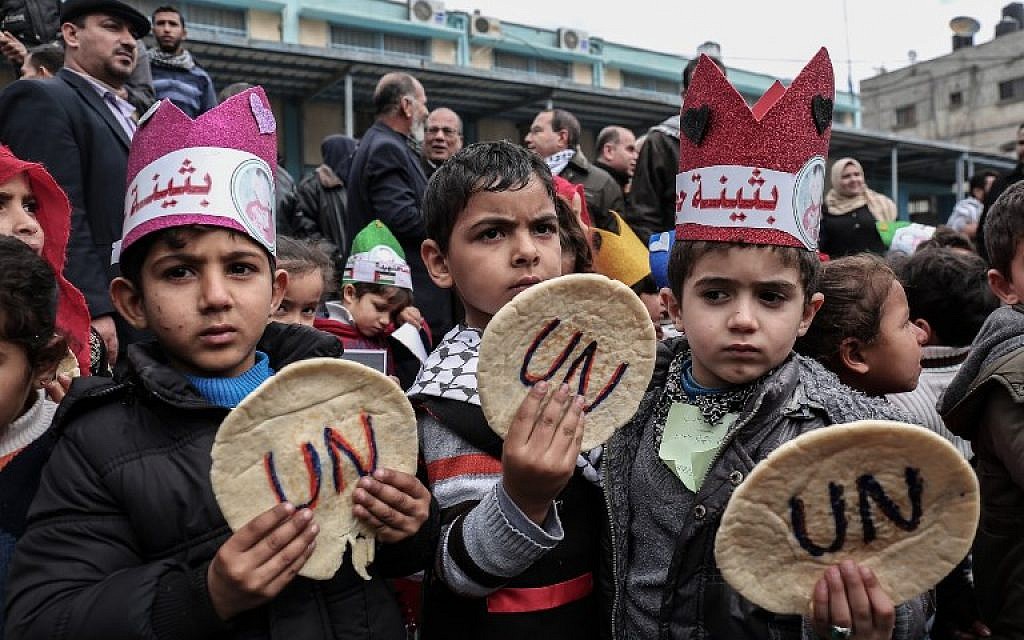 Palestinian children hold bread patties during a protest against aid cuts, outside the United Nations' offices in Khan Yunis in the southern Gaza Strip on January 28, 2018. (Said Khatib/AFP)