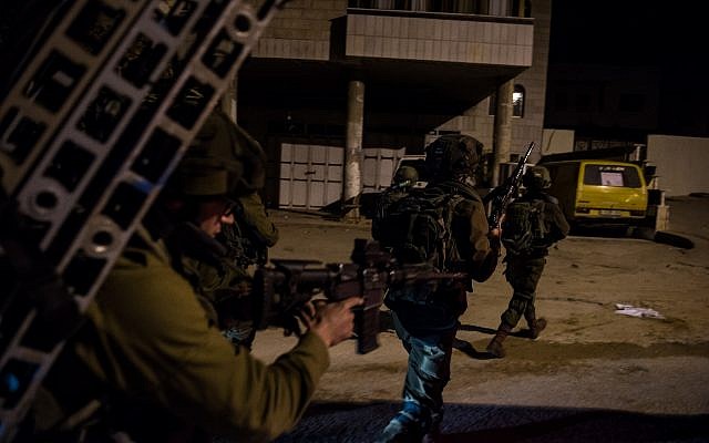 Illustrative: Israeli soldiers search the area around the West Bank city of Nablus on January 11, 2018, as part of a manhunt after the perpetrators of a lethal terror attack outside a nearby settlement. (Israel Defense Forces)