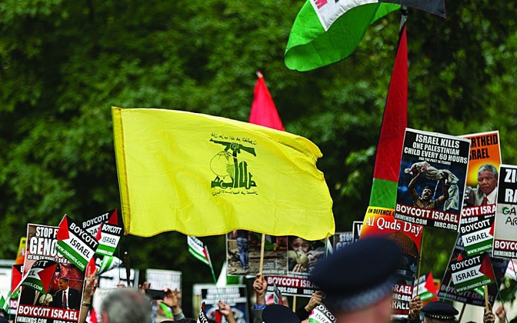 Illustrative: A Hezbollah flag is waved during an Al-Quds rally in London (Steve Winston/via Jewish News)