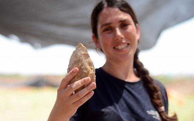 Maayan Shemer, excavation director for the Israel Antiquities Authority, showing a half-million year-old hand axe found at Jaljulia. (Samuel Magal, Courtesy of the Israel Antiquities Authority)