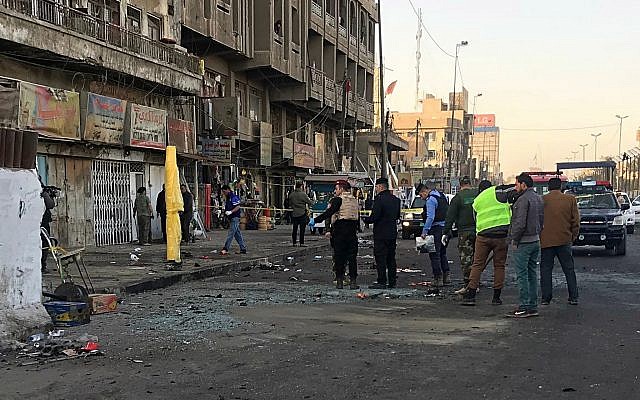 Iraqi security forces gather at the scene of a double suicide bombing in Baghdad, Iraq, January 15, 2018. (AP Photo/Ali Abdul Hassan)