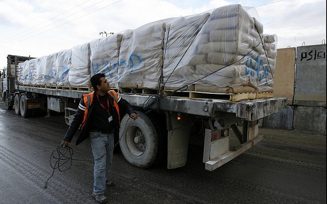Illustrative: UN trucks carrying building materials for projects funded by UNRWA arrive in Rafah in the southern Gaza Strip after crossing the Israeli Kerem Shalom crossing on December 10, 2013. (Abed Rahim Khatib/ Flash90/ File)