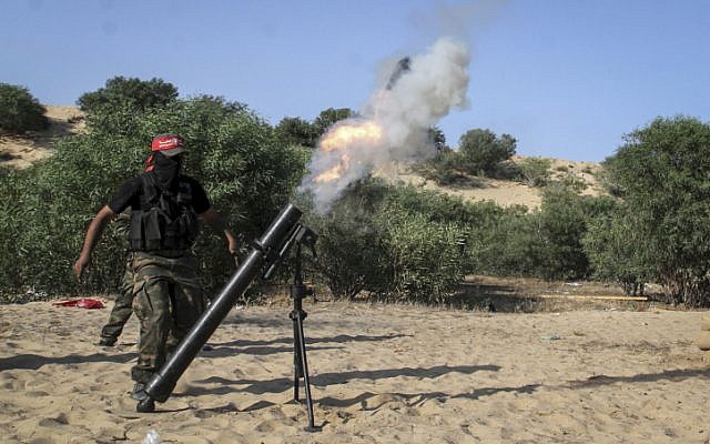 Illustrative: Palestinian terrorists fire a mortar shell during a graduation ceremony in Rafah in the southern Gaza Strip, on May 29, 2015. (Abed Rahim Khatib/Flash90)