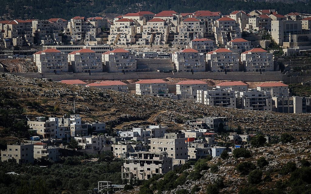 Illustrative photo of the ultra-Orthodox West Bank settlement of Beitar Illit, and the Arab village of Wadi Fukin below, June 17, 2015. (Nati Shohat/Flash90)