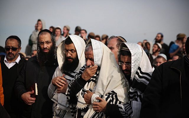 Friends and family attend the funeral of Rabbi Raziel Shevach, 35, in the West Bank outpost of Havat Gilad on January 10, 2018. (Miriam Alster/Flash90)