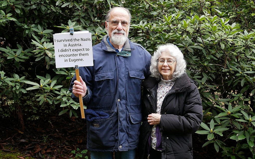 George and Judy Tanner pose with the sign they held at a February rally after a surge in neo-Nazi and anti-Semitic graffiti appeared in Eugene, Oregon. (Judy Tanner)