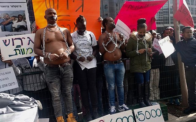 Eritrean activists held a mock slave auction to protest planned deportations outside of the Rwandan embassy in Herzilya on January 22, 2018. (Melanie Lidman/Times of Israel)