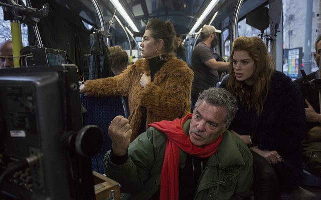 Amos Gitai (bottom) with Keren Mor (left) and Yuval Sherf, checking takes during filming of 'Jerusalem Light Rail.' The director will be honored at the Solidarity and Human Rights Film December 9-18, 2021 for 40 years of making films about human rights (Courtesy Amos Gitai)
