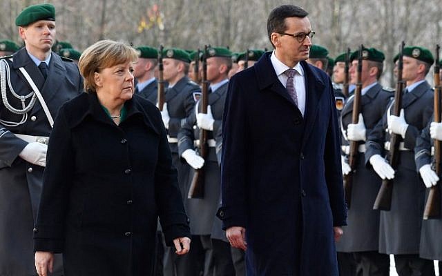 File: German Chancellor Angela Merkel and Polish Prime Minister Mateusz Morawiecki inspect a military honor guard on February 16, 2018 in front of the Chancellery in Berlin. (AFP Photo/John Macdougall)
