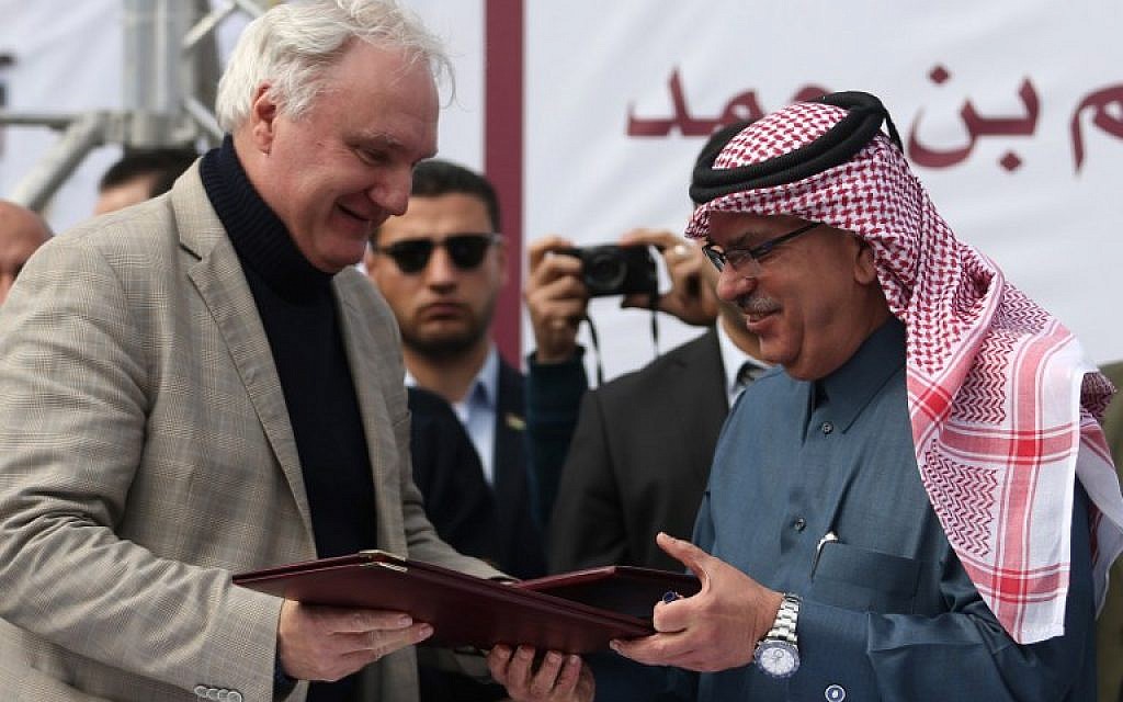 Qatari Ambassador to Gaza Mohammed al-Emadi (R) and Director of UNRWA Operations in Gaza Matthias Schmale exchange documents after Qatar signed an agreement to provide a nine million dollar humanitarian relief grant to residents of the Gaza Strip following a press conference at the Dar al-Shifa hospital in Gaza City on February 19, 2018. (AFP PHOTO / MOHAMMED ABED)