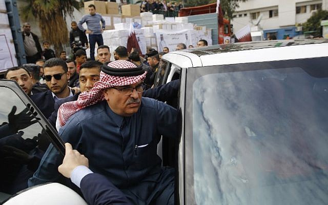 Qatari envoy Mohammed Al-Emadi (C) leaves a press conference at the Dar al-Shifa hospital in Gaza City, on February 19, 2018. (AFP Photo/Mohammed Abed)