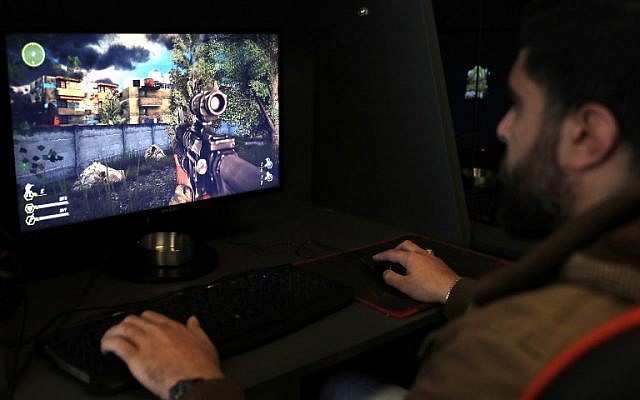 A Lebanese man plays a computer game created by the Hezbollah terror group called "Sacred Defense" in a southern suburb of Beirut on February 27, 2018. (AFP Photo/Joseph Eid)