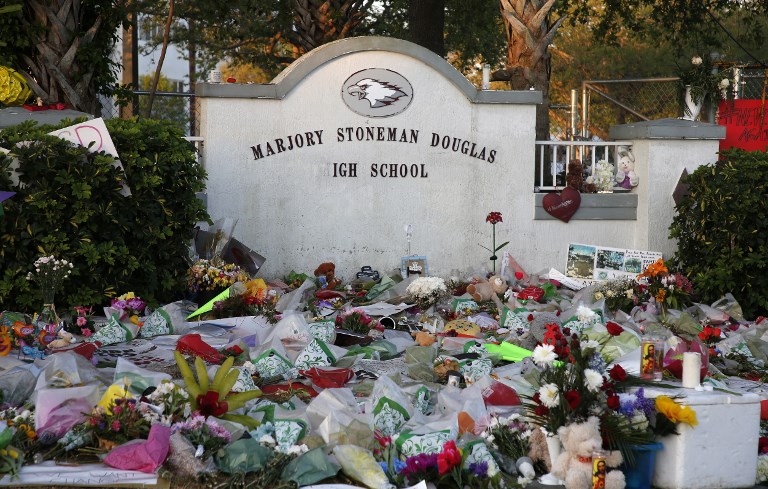 Flowers, candles and mementos sit outside one of the makeshift memorials at Marjory Stoneman Douglas High School in Parkland, Florida on February 27, 2018. (AFP PHOTO / RHONA WISE)