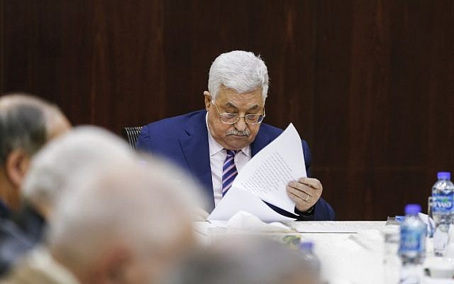 Palestinian president Mahmoud Abbas reads notes as he chairs a meeting of the Palestine Liberation Organization Executive Committee at the Palestinian Authority headquarters in the West Bank city of Ramallah on February 3, 2018. (AFP/ABBAS MOMANI)