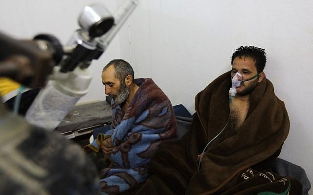 Syrians reportedly suffering from breathing difficulties following Syrian regime air strikes on the northwestern town of Saraqeb at a field hospital in a village on the outskirts of Saraqeb, due to the lack of hospitals in the town, on February 4, 2018. (AFP / OMAR HAJ KADOUR)