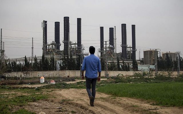 A Palestinian youth walks towards the Gaza strip's sole electricity plant, which provides a fifth of the embattled region's power needs, after it stopped working at midnight the previous night due to lack of fuel, as per local officials, on February 15, 2018. (Mohammed Abed/AFP)
